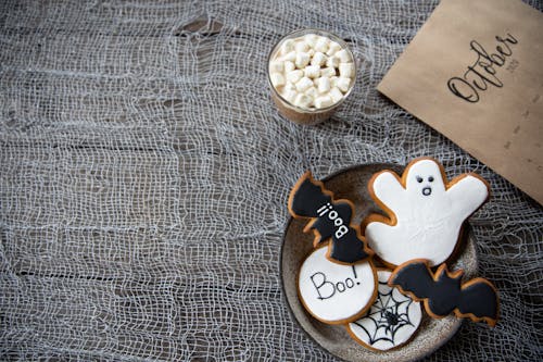 Free White and Black Halloween Treats On Round Plate Stock Photo