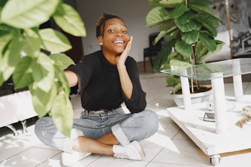 Free A Woman Smiling holding the Plant Stock Photo