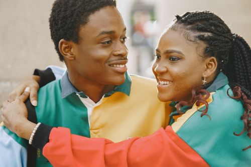 Free Joyful couple in colorful jackets sharing a heartfelt embrace outdoors. Stock Photo