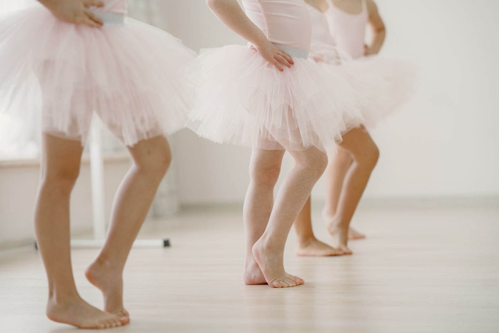 Instructor guiding first-time participants through choreography in a dance studio class