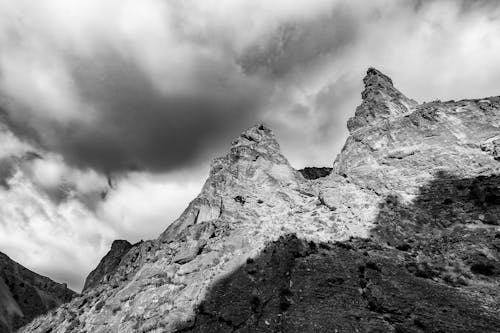 Majestic rough rocky cliffs under stormy sky