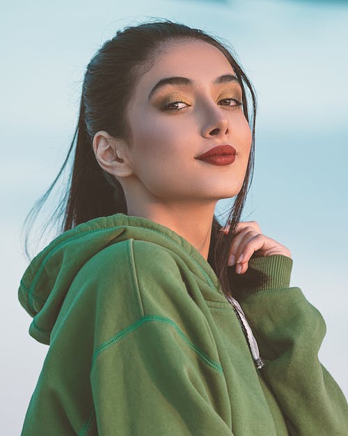 Free Beautiful Young Girl Wearing a Green Hoodie  Stock Photo