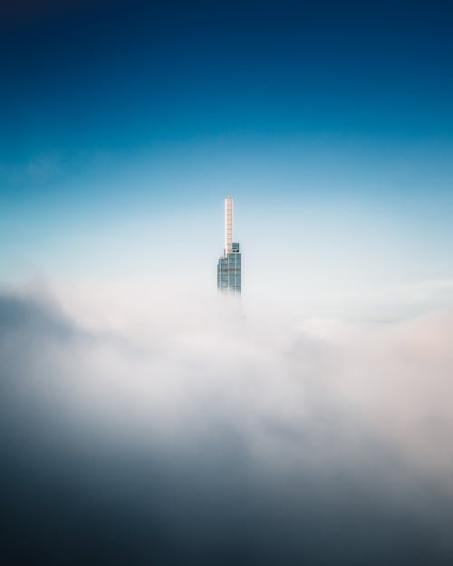 High Rise Building Above White Clouds 