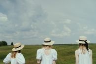 Girls in Standing on the Green Grass Field