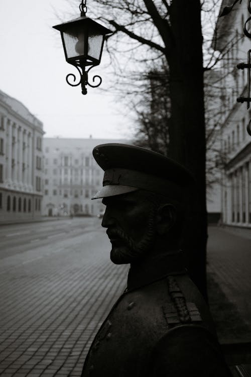 Grayscale Photo of Man in Hat and Coat