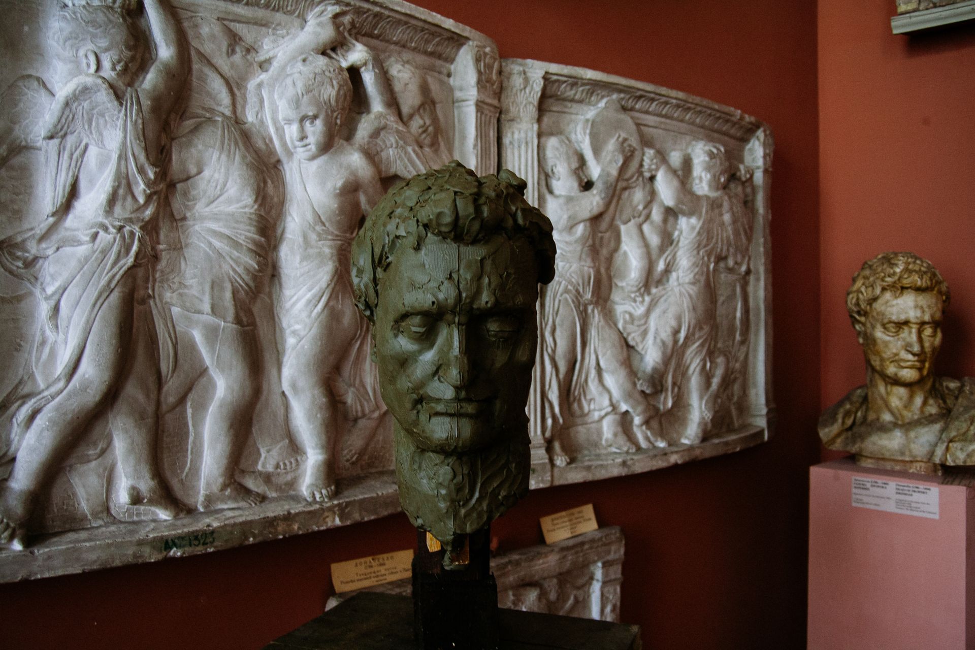Bust sculptures and bas relief art pieces displayed in a Saint Petersburg museum exhibit.