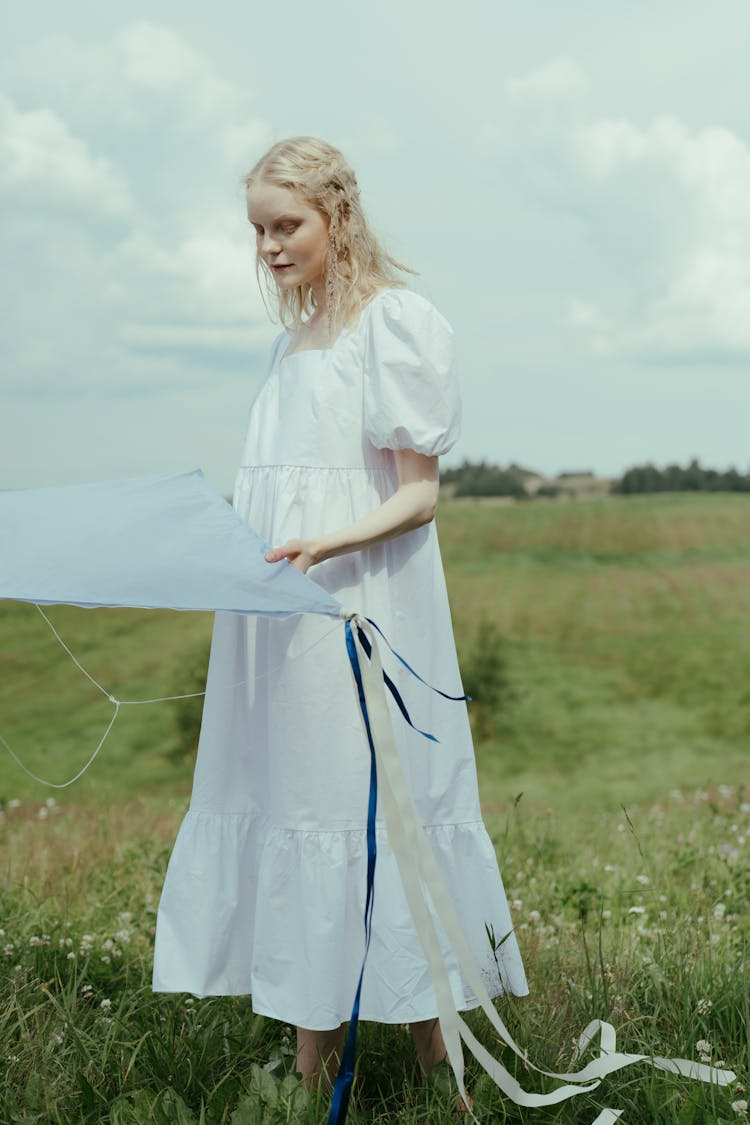 Women In White Dress Holding A Kite