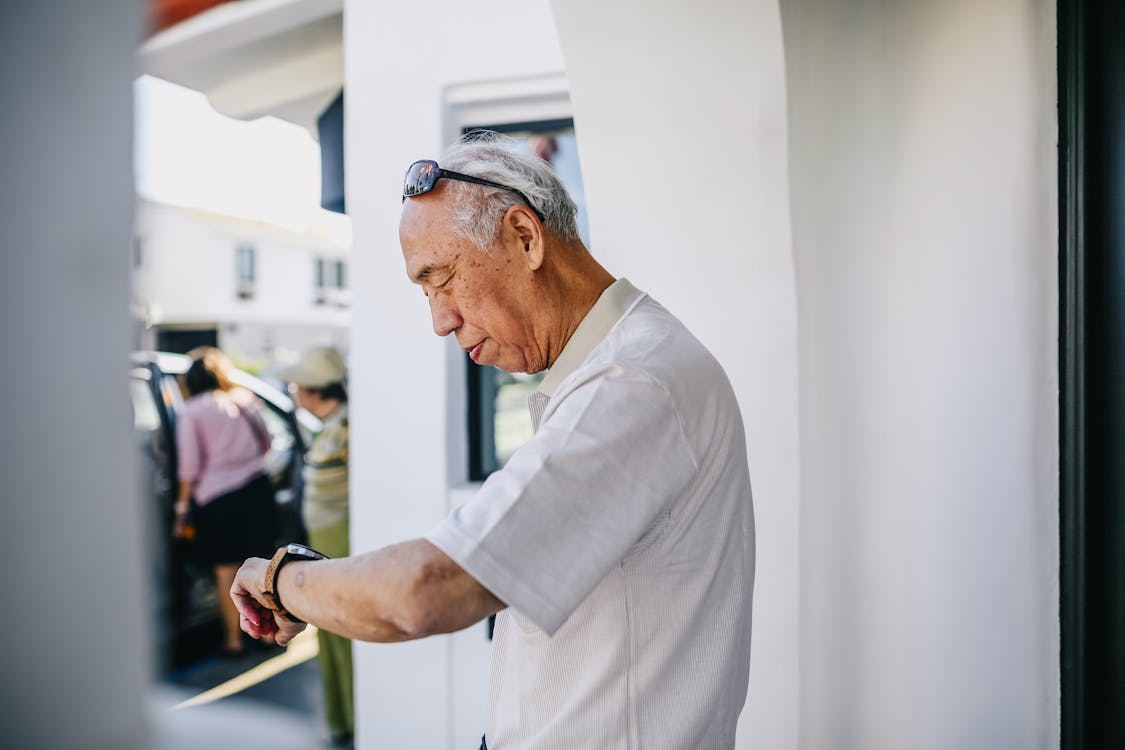 Man in White Dress Shirt Checking on the Time