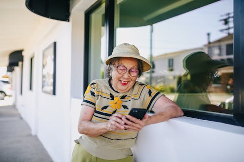 Old Lady Smiling while Texting