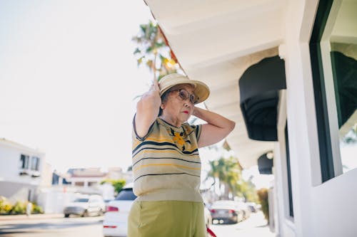 Free Old Lady Fixing Her Hat Stock Photo