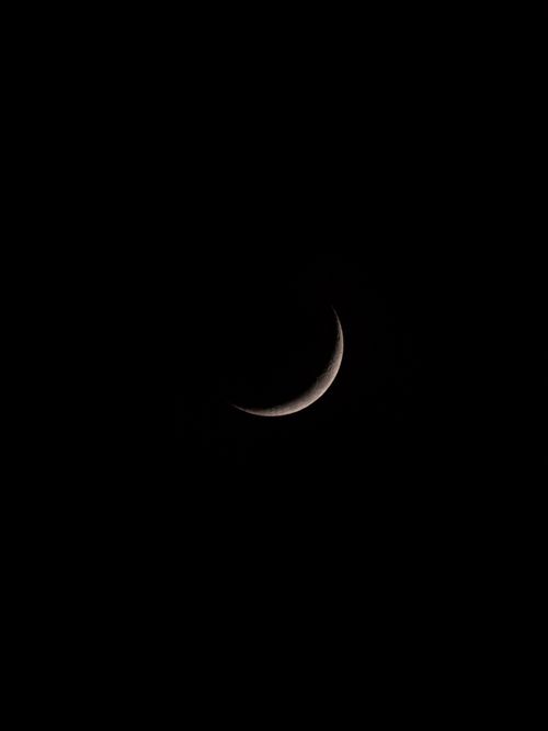 Free A serene crescent moon in a clear dark sky perfect for night-themed designs. Stock Photo