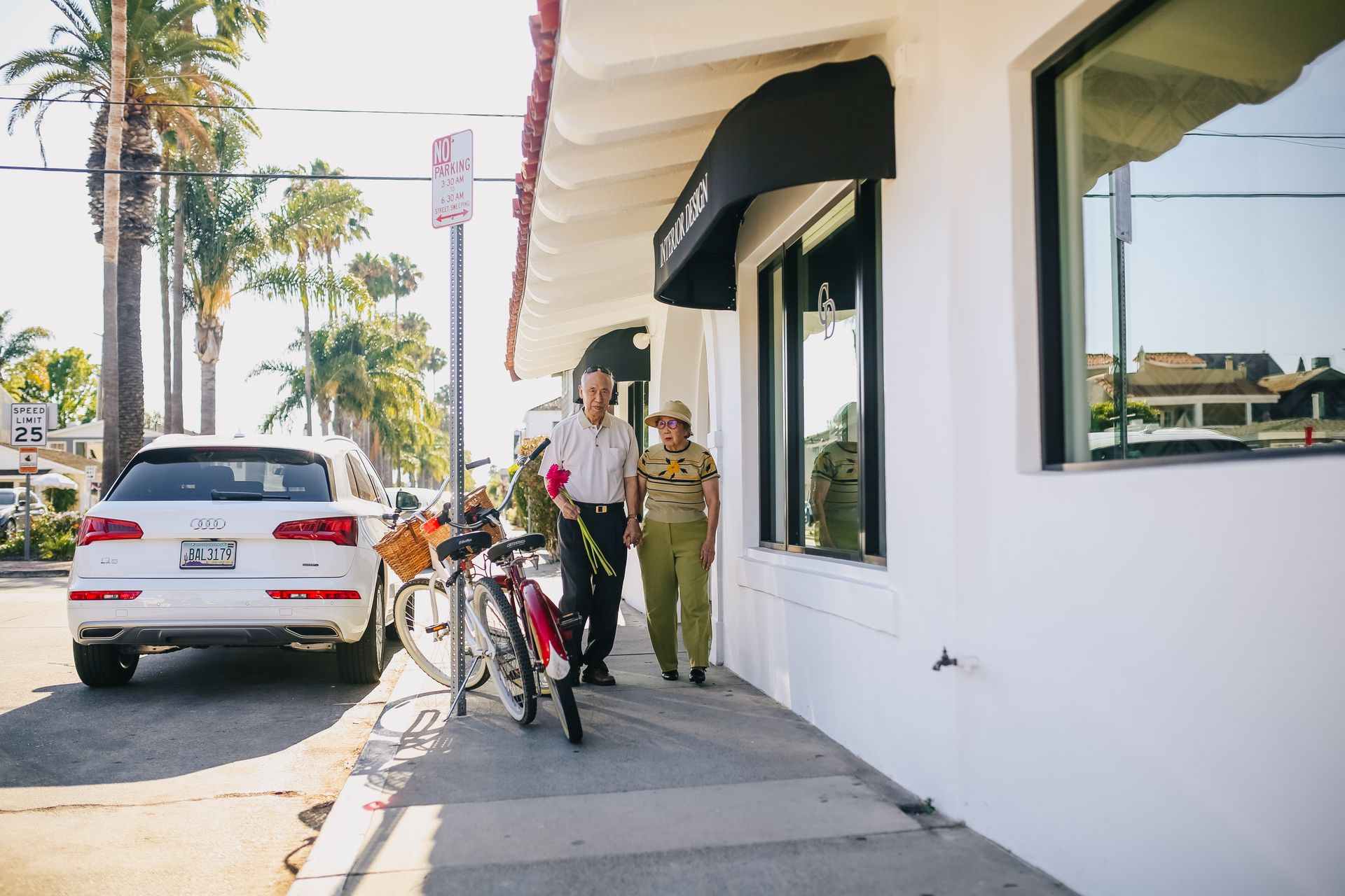 Elderly Couple Walking On Sidewalk
