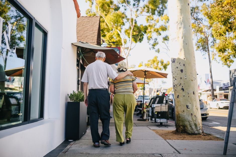 A senior couple walking through a Chicago park - major life transitions