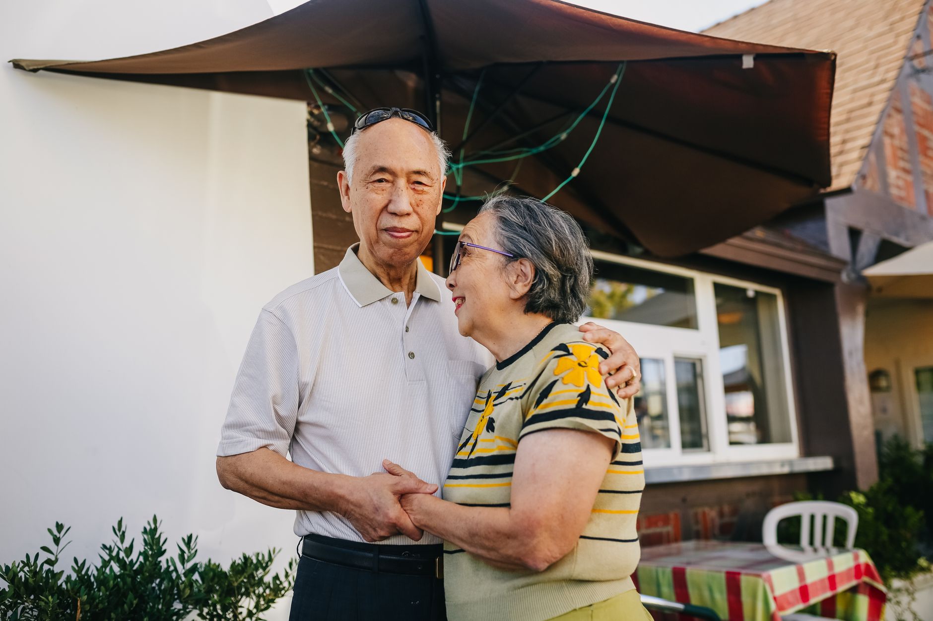 A happy senior couple sharing a tender moment outdoors, expressing love and affection.