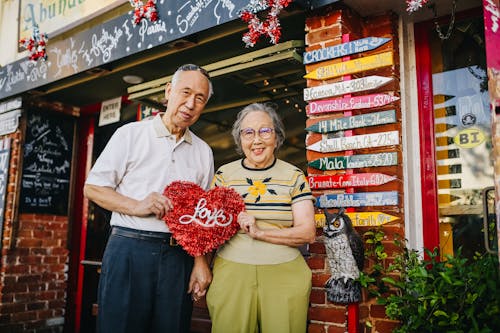 Elderly Couple Holding Red Heart