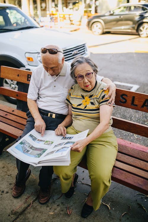 Elderly Couple Sitting on Wooden Bench