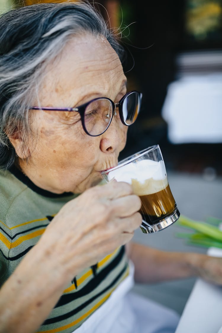 Old Woman Drinking Hot Coffee