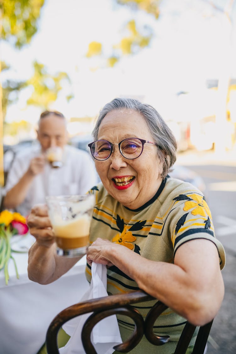 Smiling Elderly Woman While Drinking Chocolate