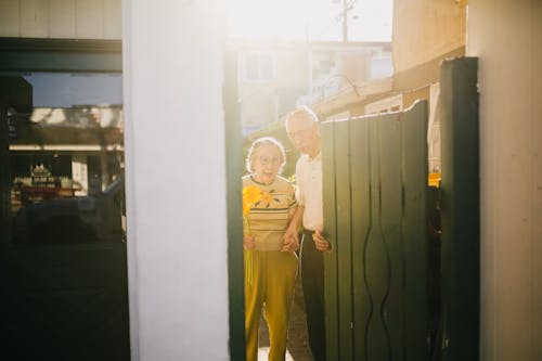 Elderly Couple Exiting the Gate