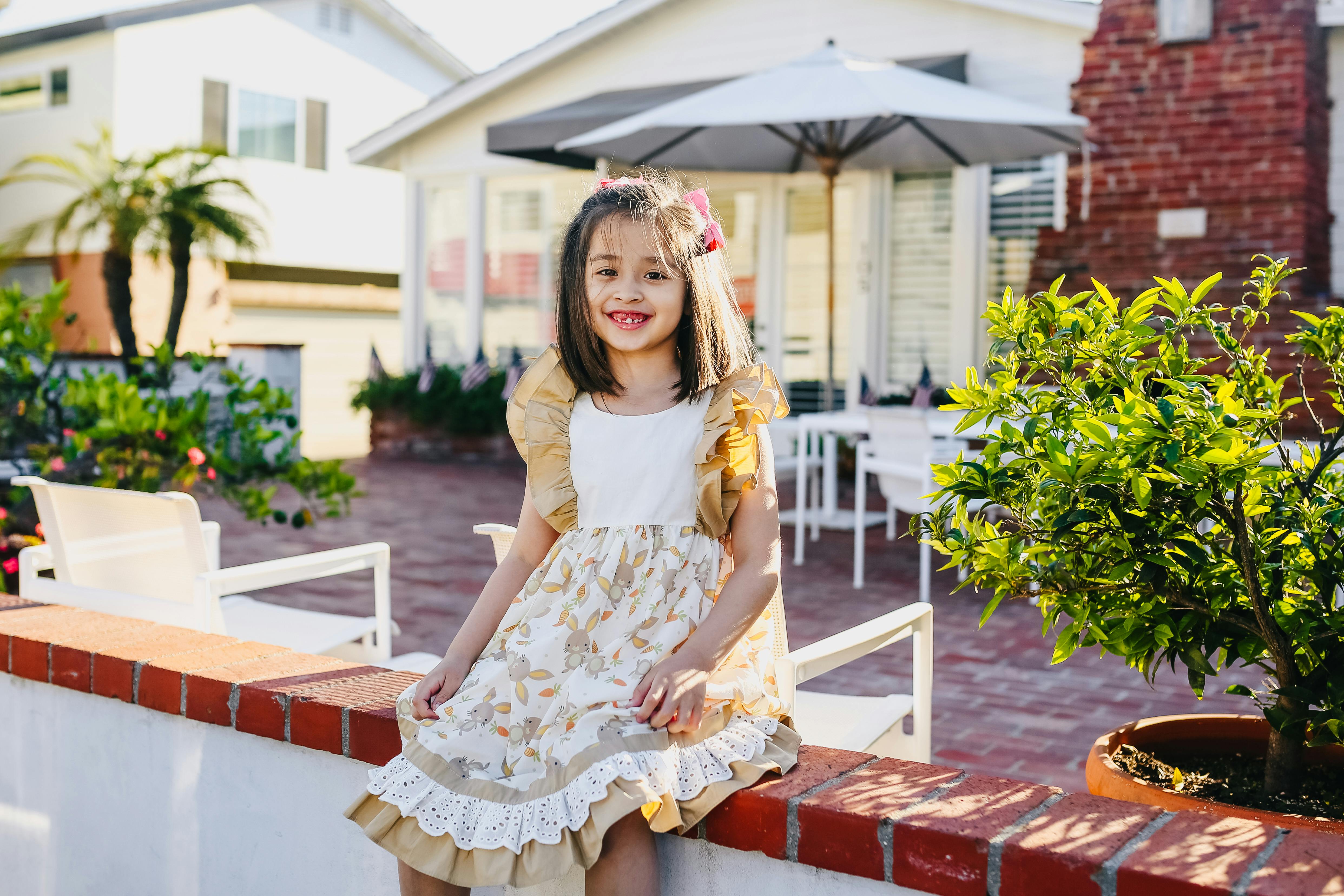 little girl in brown dress