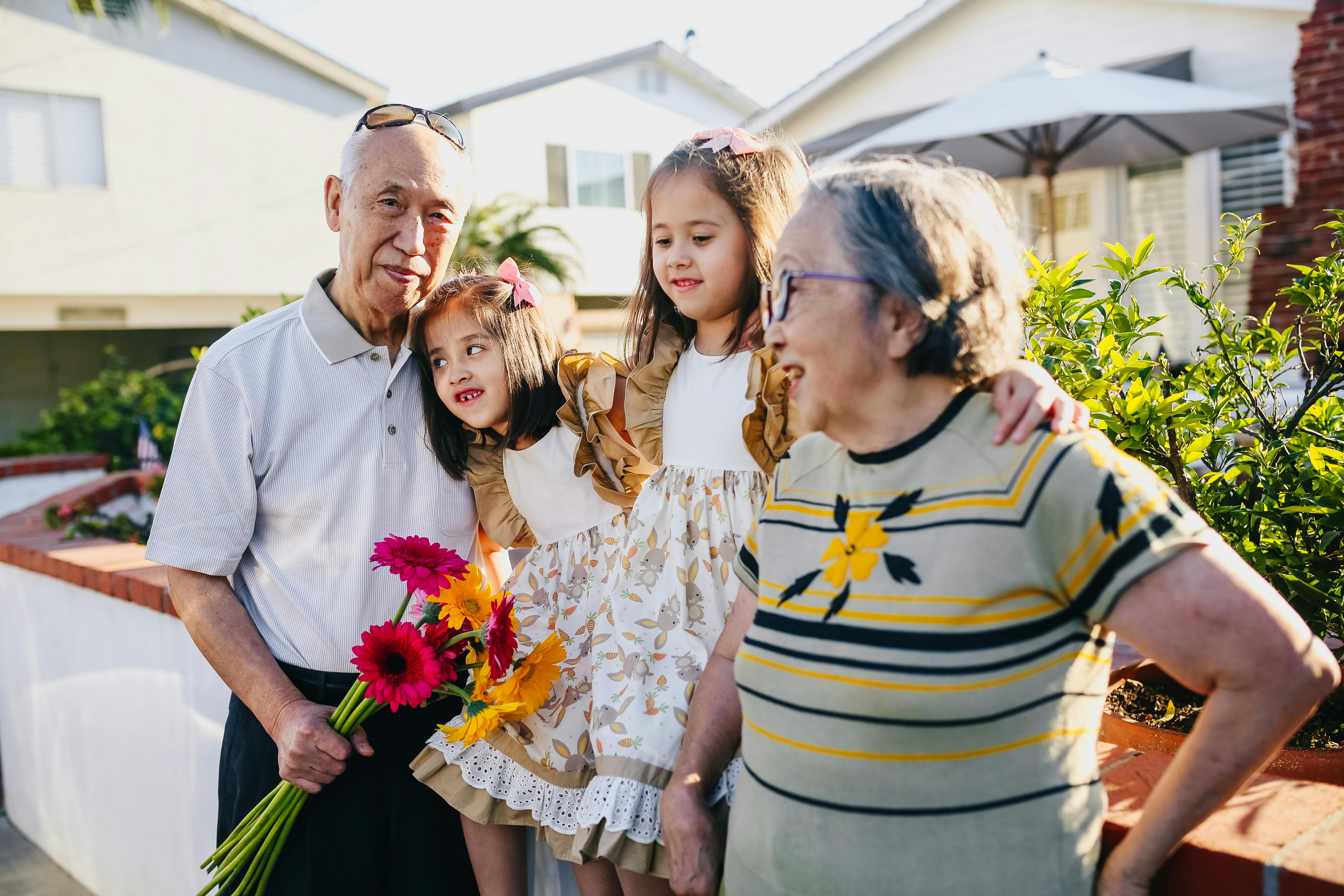 A photo of two girls with their grandfather and grandmother