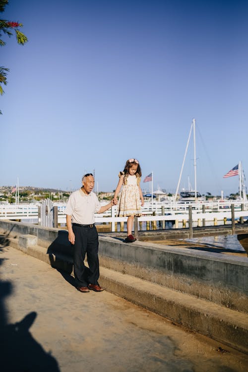 Little Girl with Her Grandpa Walking