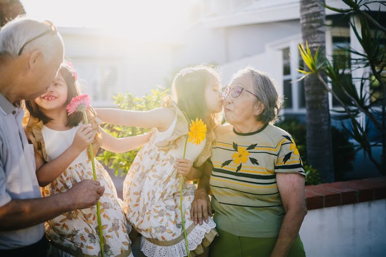 Grandchildren Kissing Their Grandparents