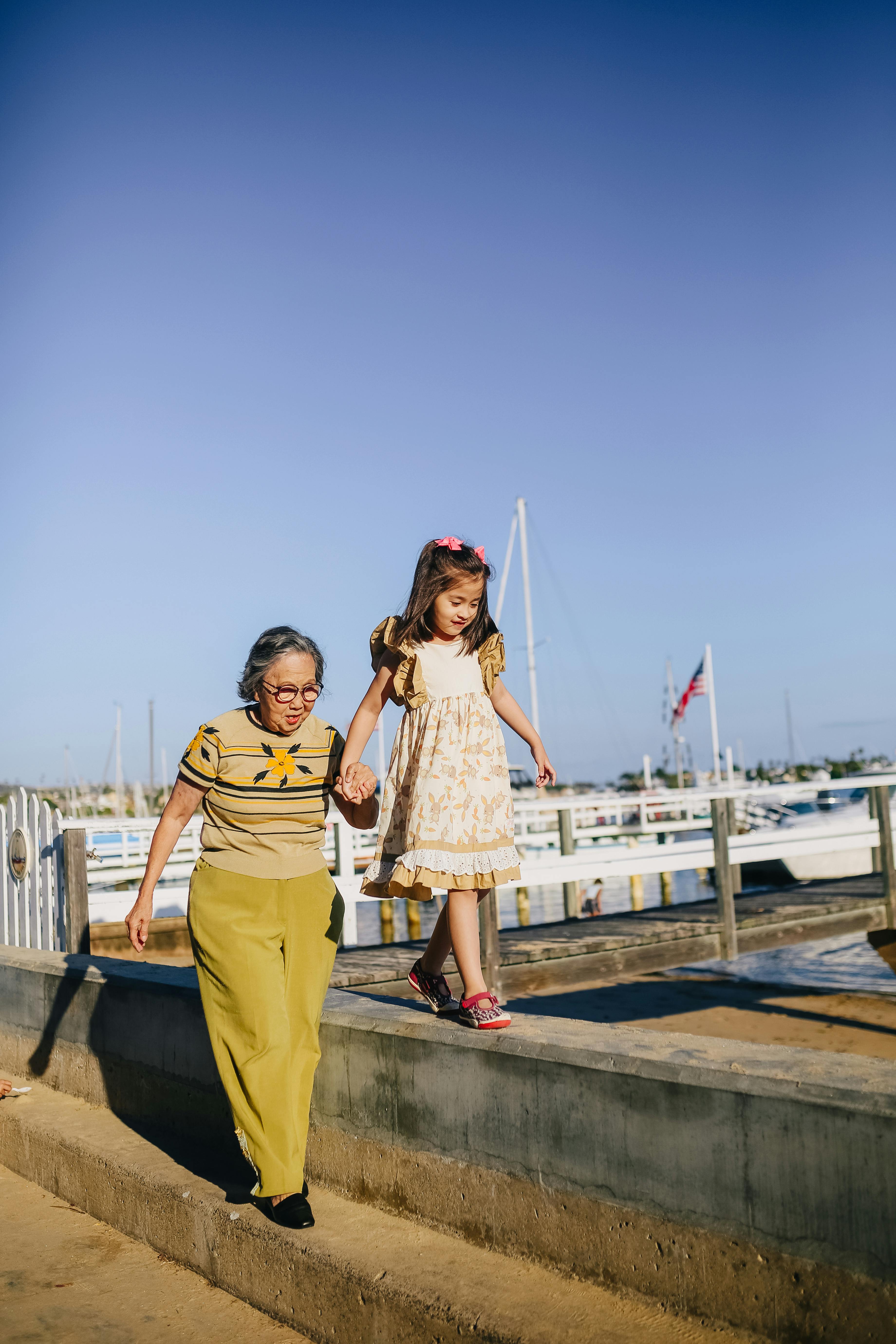 grandma holding her granddaughter while walking