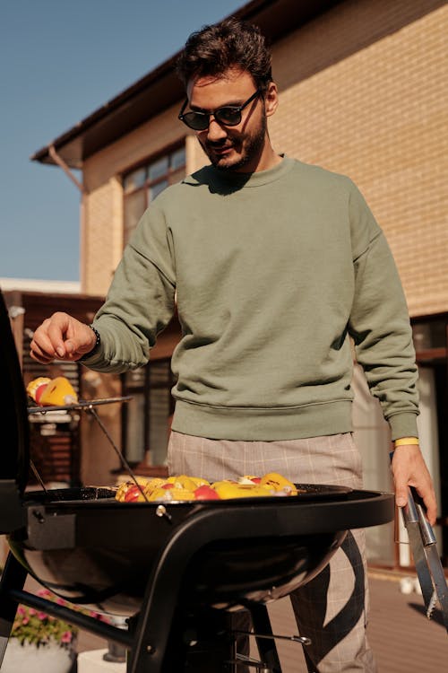 Free Man in Black Sunglasses Grilling Vegetables Stock Photo