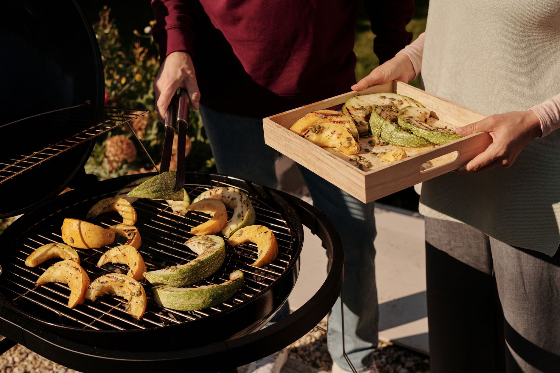 Sliced zucchini and squash on a gas grill with grill marks