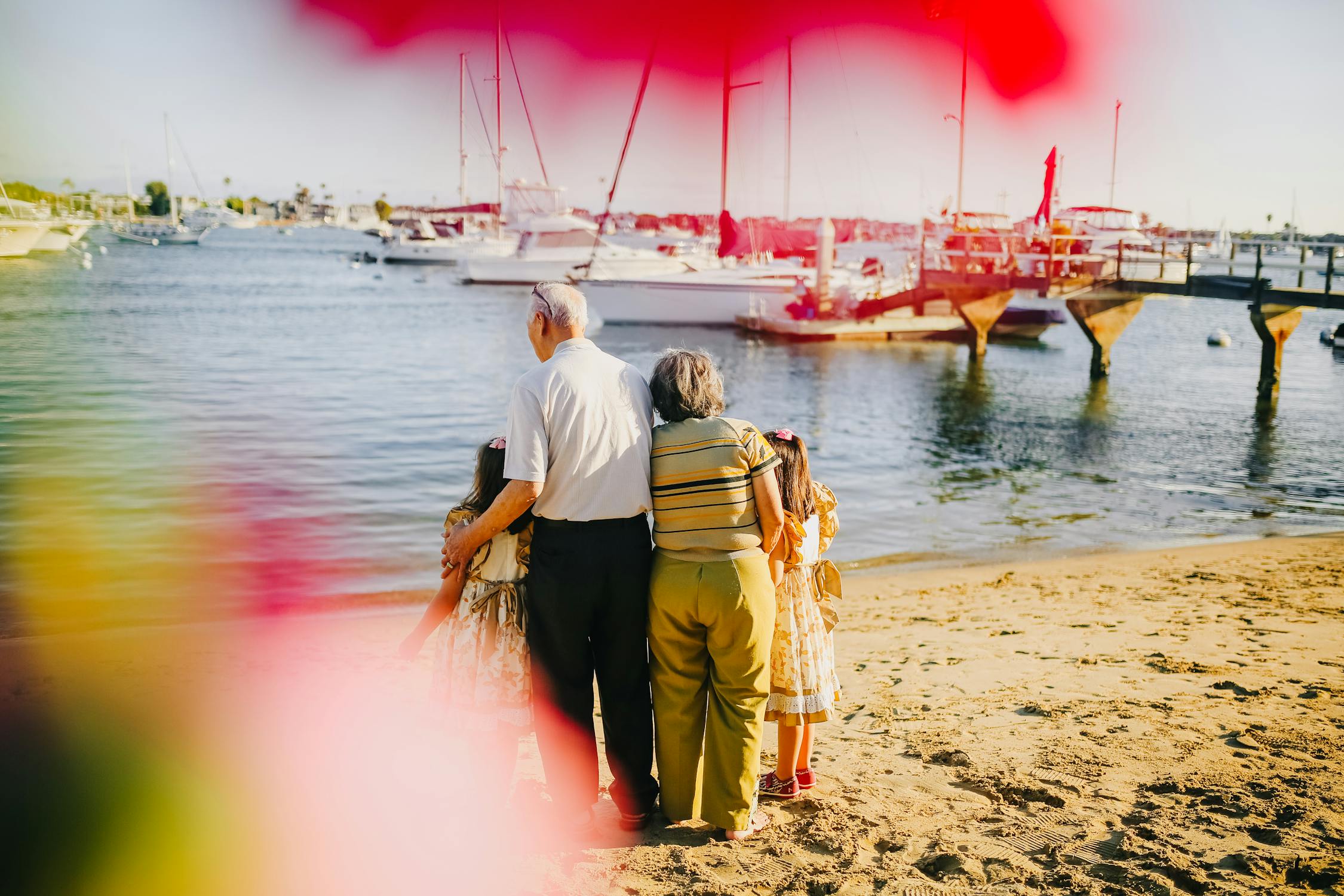 Grandparents With Their Granddaughters Standing By The Shore · Free Grandparents With Their Granddaughters Standing By The Shore · Free