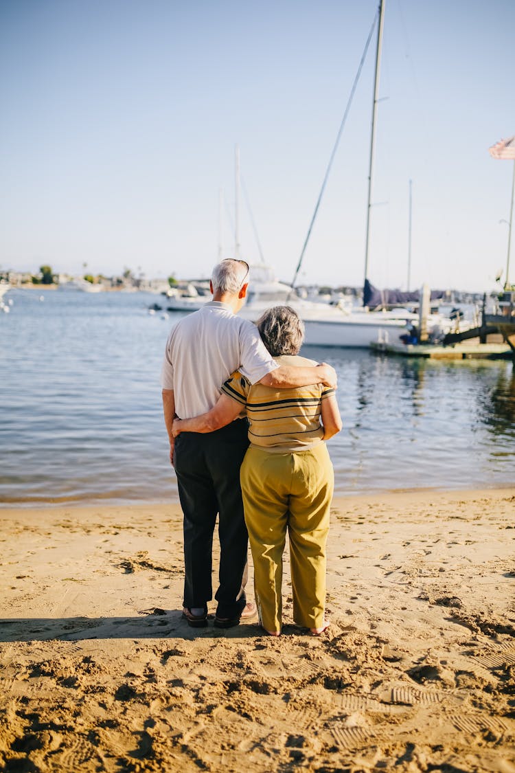 Elderly Couple Standing On The Shore