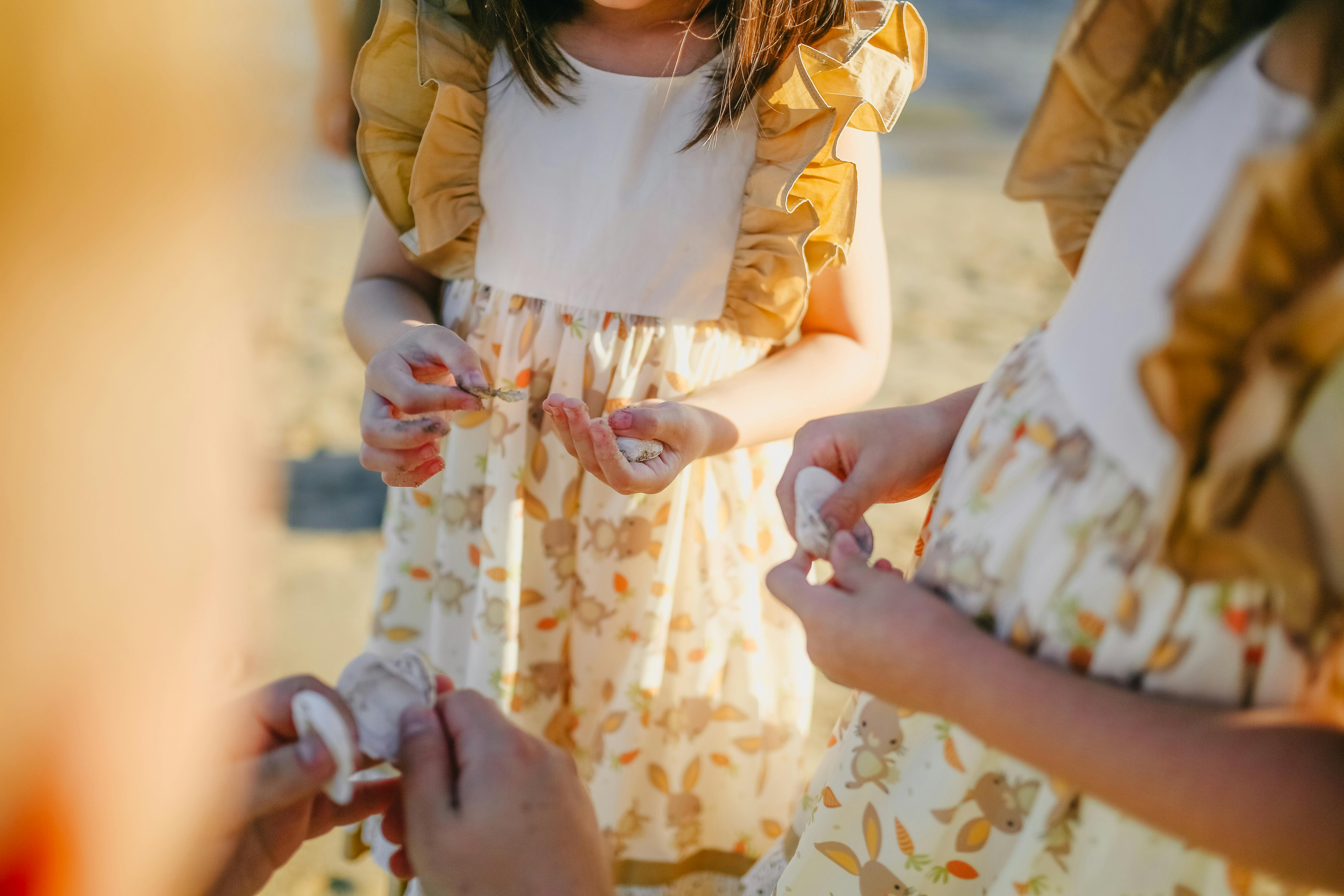 girls holding seashells