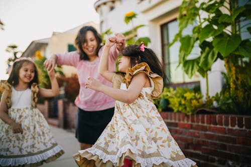 Free Mother Dancing with Her Daughters on the Street Stock Photo