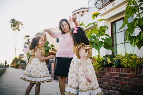 Free Mother Dancing with Her Daughters on the Street Stock Photo