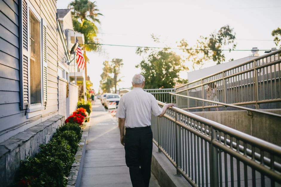 man removing flag railing