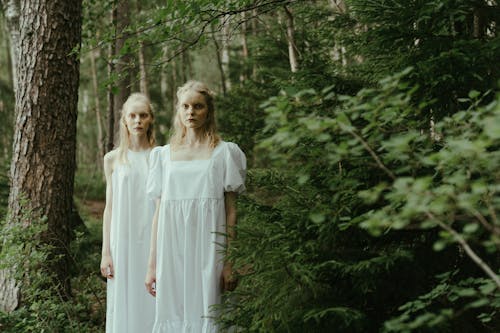 Twin Sisters Standing in a Forest