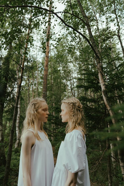 Twin Sisters Standing in a Forest