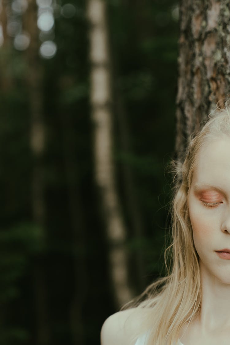 Half Face Of A Woman Leaning On A Tree 