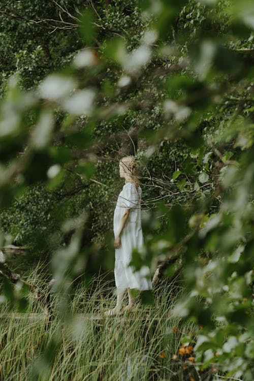 Blonde Woman in White Dress in Forest