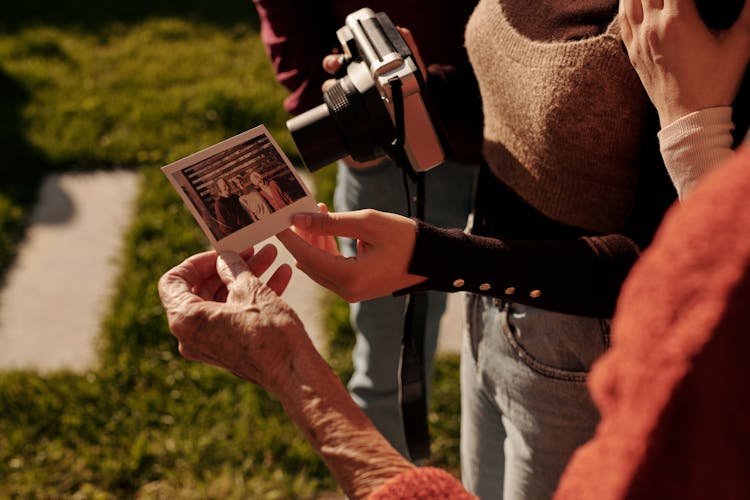 People Looking At The Polaroid Photo