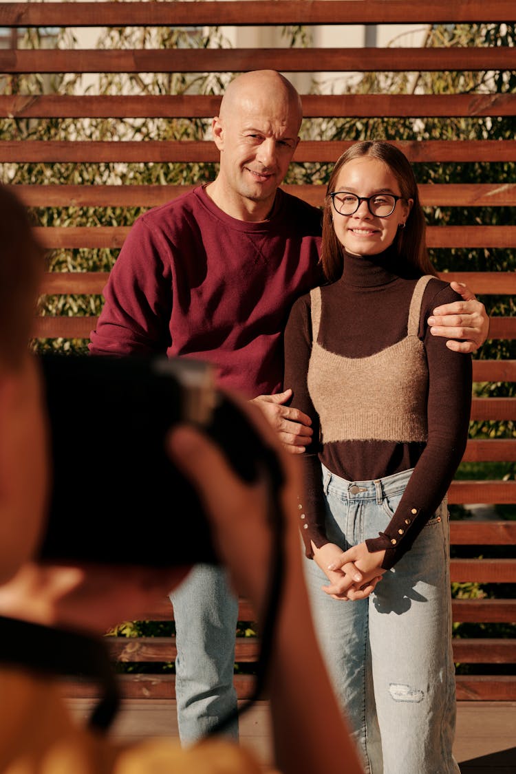 Photographer Taking Pictures Of Smiling Couple