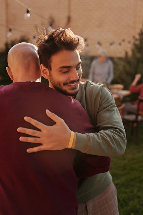Man in Gray Long Sleeve Shirt Hugging Woman in Gray Long Sleeve Shirt