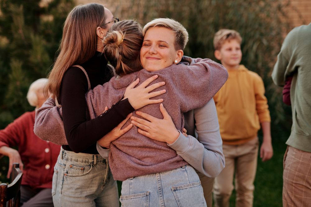 People embracing together outdoors