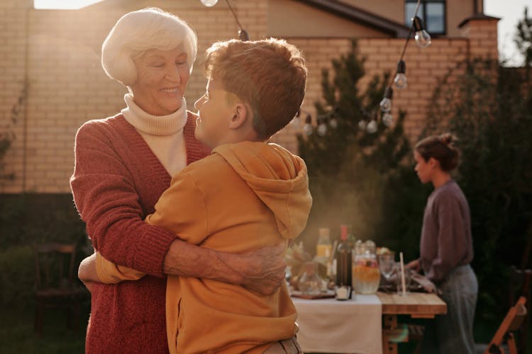 Elderly Woman Hugging Her Grandson