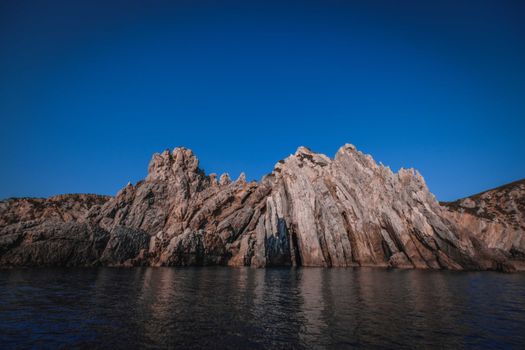 Kara Dag Mountain against rippled Black Sea under bright sky in Republic of Crimea Russia