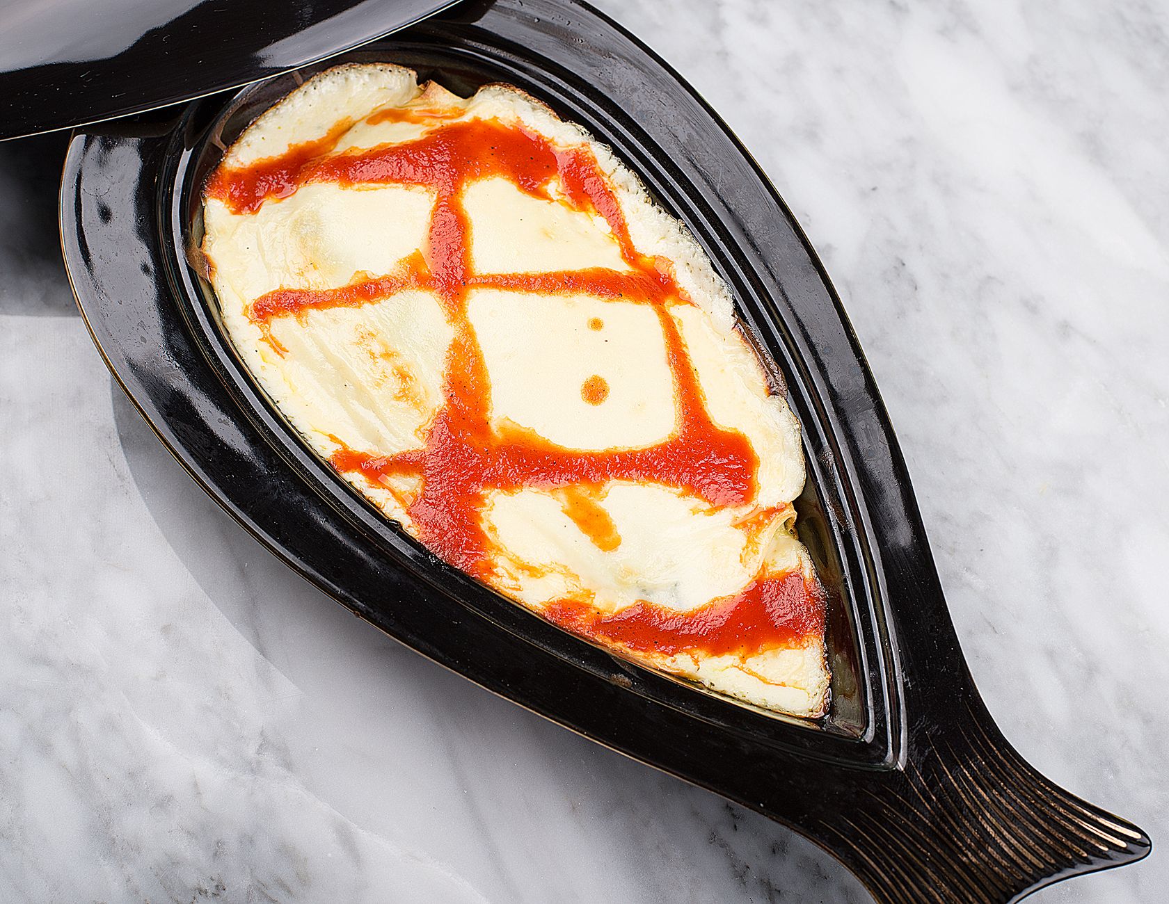 Poached fish quenelles with creamy sauce