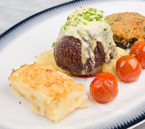 Photo of a Dish with Steak and Tomatoes