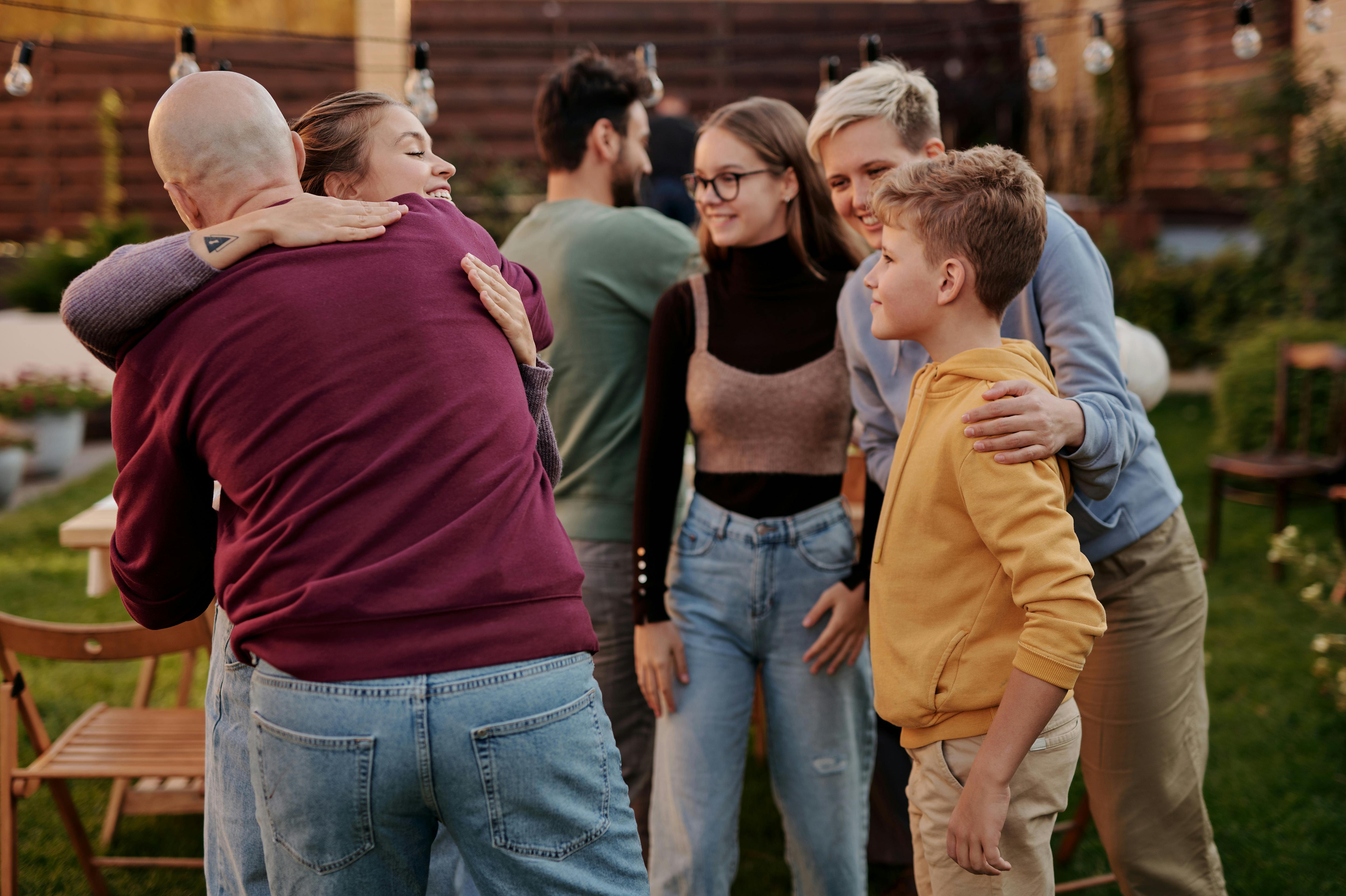 Happy multiethnic friends sitting in park · Free Stock Photo