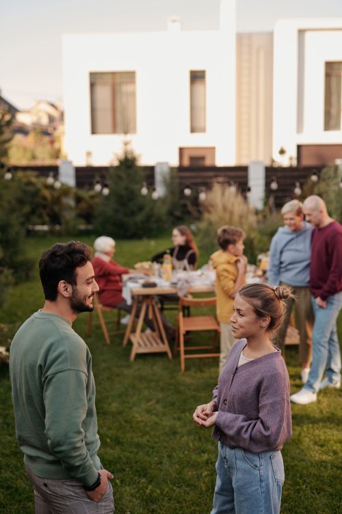 Free A warm family gathering outdoors with people chatting and enjoying the day. Stock Photo